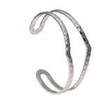 A silver-toned hammered open cuff bangle bracelet. 
